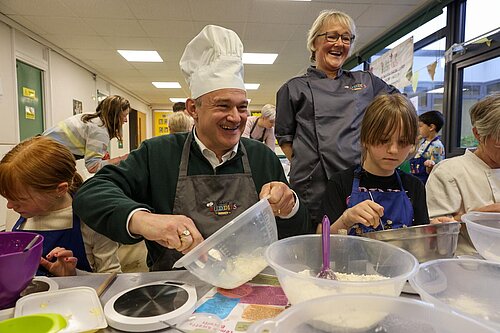 Ed Davey visits a school in Hertfordshire and joins in a baking lesson